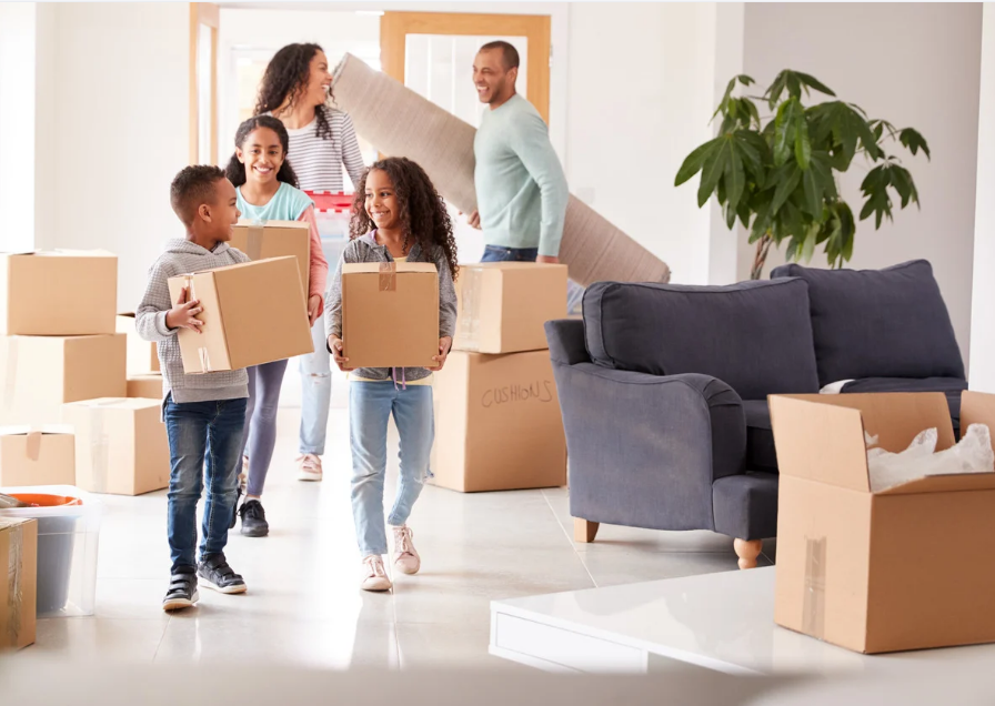 Family moving boxes into new home