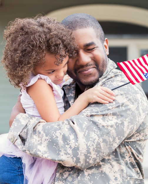 Military father hugging daughter